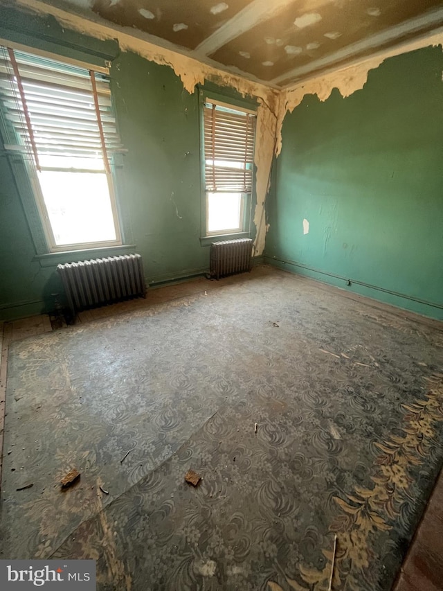 spare room featuring radiator heating unit