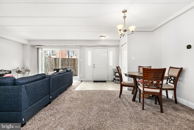 carpeted dining room with a notable chandelier