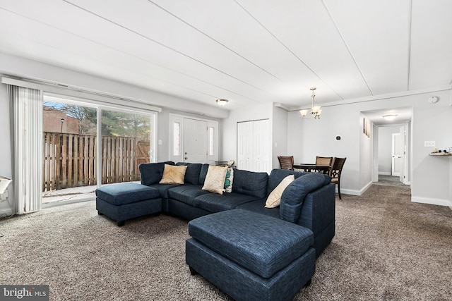 carpeted living room with a notable chandelier