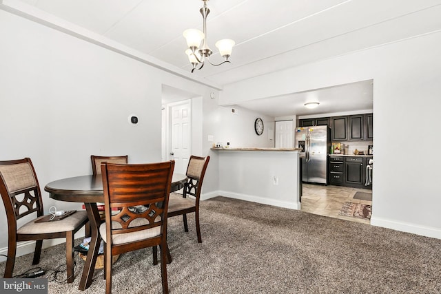 carpeted dining room featuring a chandelier