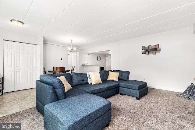 living room with carpet flooring and a notable chandelier