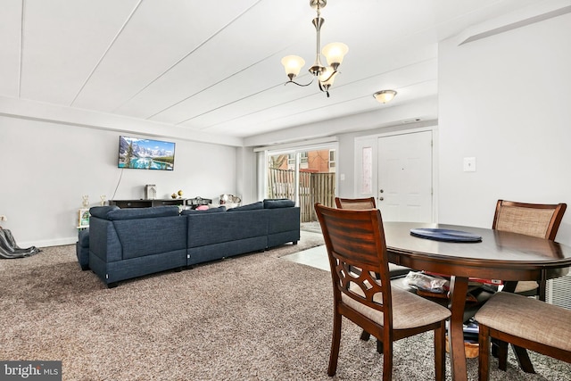 carpeted dining room with a notable chandelier