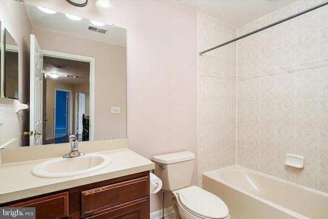 full bathroom featuring toilet, tiled shower / bath combo, and vanity