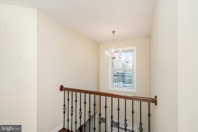 stairway with an inviting chandelier