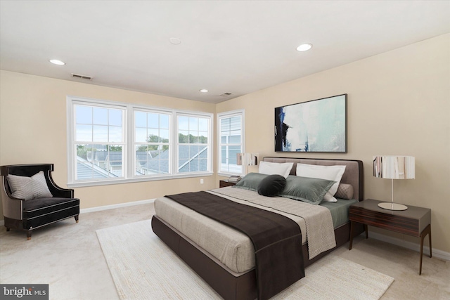 carpeted bedroom featuring multiple windows