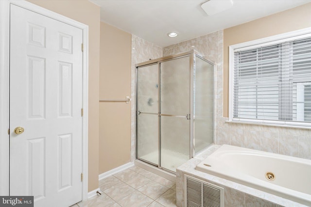 bathroom featuring plus walk in shower and tile patterned flooring