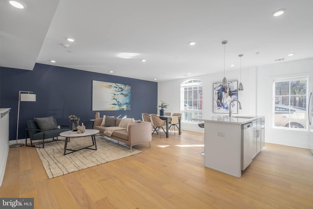 living room featuring sink and light wood-type flooring