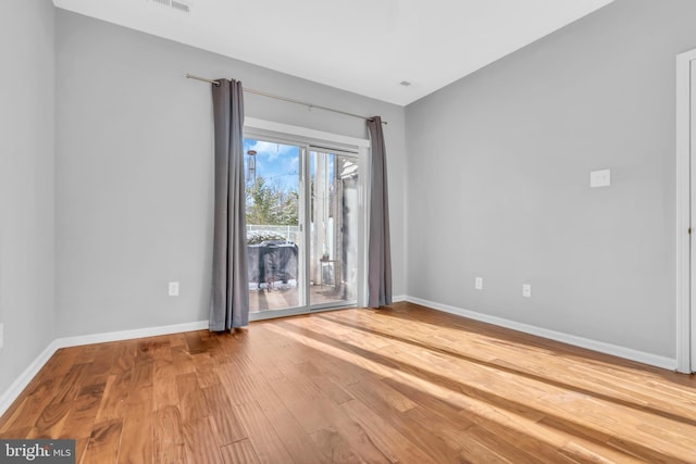 spare room featuring hardwood / wood-style floors