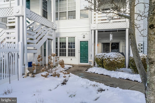 view of snow covered property entrance