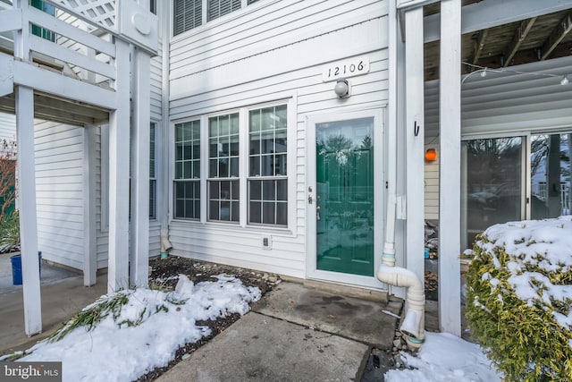 view of snow covered property entrance