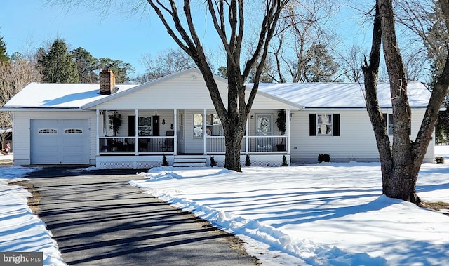 ranch-style house with a porch and a garage