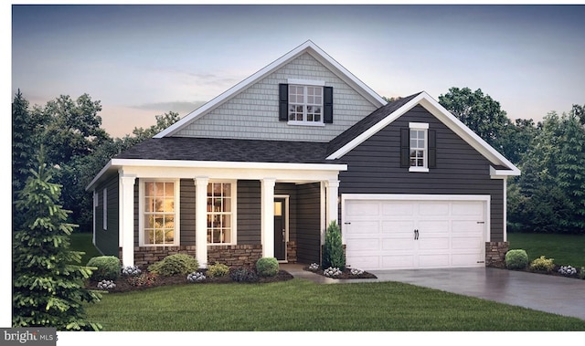 craftsman inspired home with a lawn and a garage