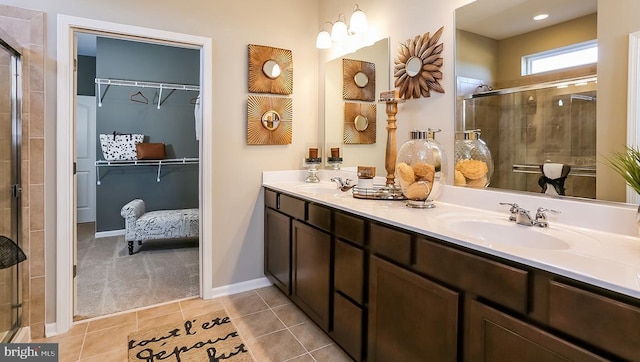 bathroom with tile patterned flooring, walk in shower, and vanity