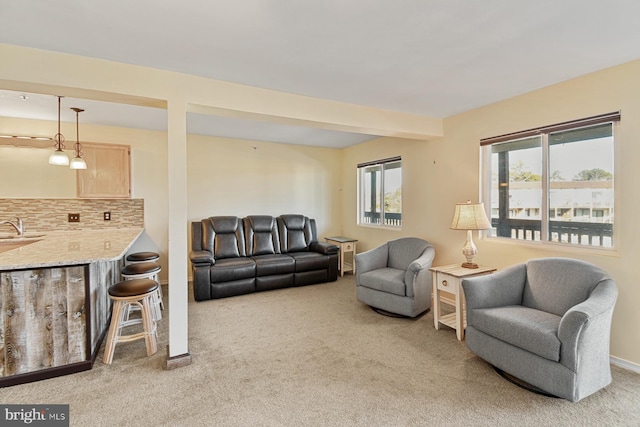 carpeted living room featuring sink