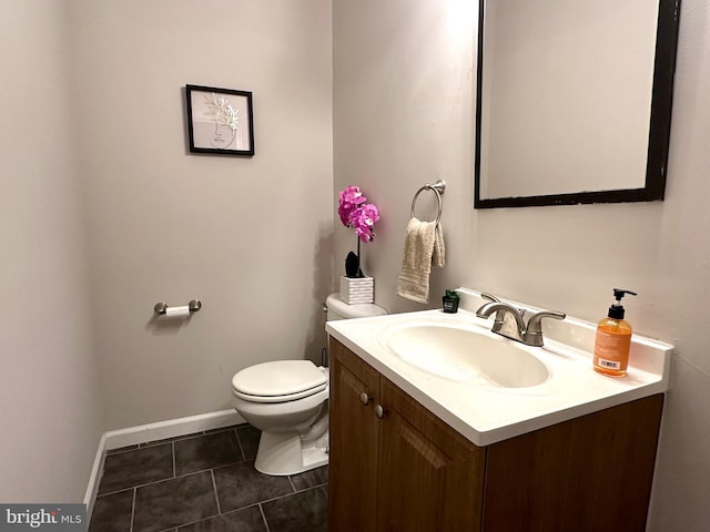 bathroom featuring toilet, vanity, and tile patterned floors