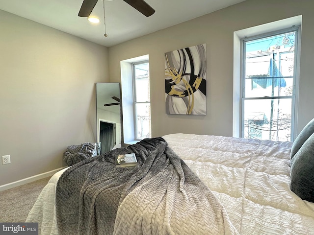 carpeted bedroom with ceiling fan