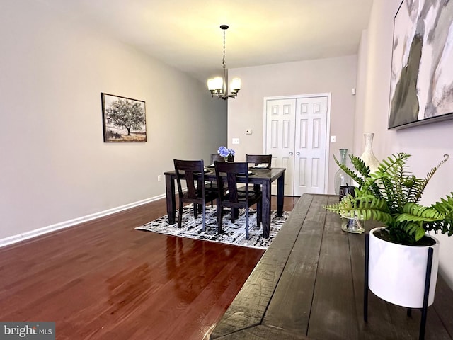 dining room featuring an inviting chandelier and dark hardwood / wood-style floors