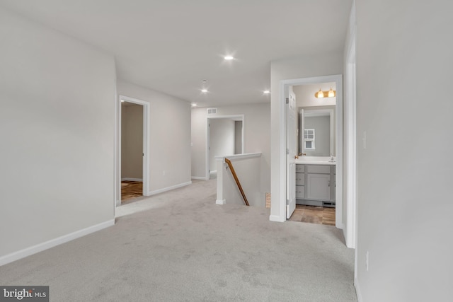 interior space featuring carpet flooring, recessed lighting, visible vents, and baseboards