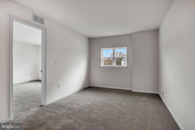 carpeted empty room with baseboards and visible vents