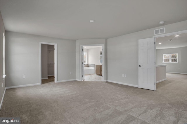 spare room with recessed lighting, visible vents, baseboards, and light colored carpet