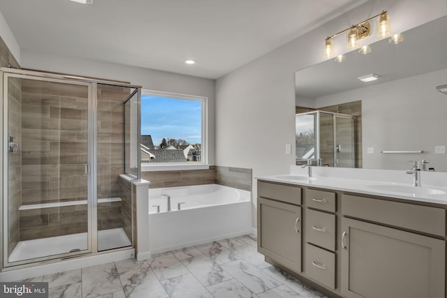 bathroom with a garden tub, marble finish floor, a sink, a shower stall, and double vanity