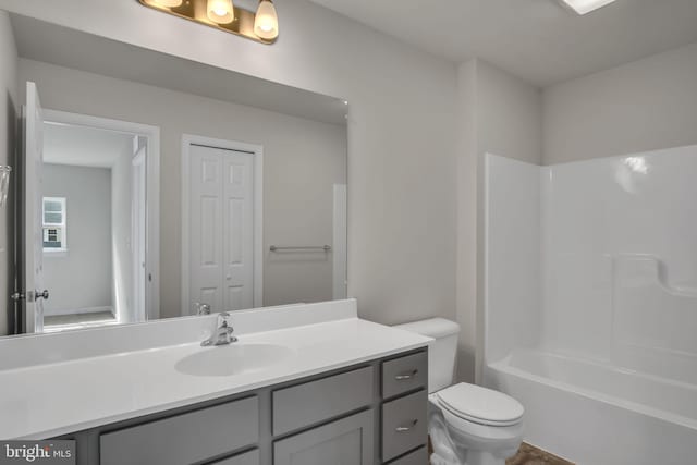 bathroom with vanity, toilet, and tub / shower combination