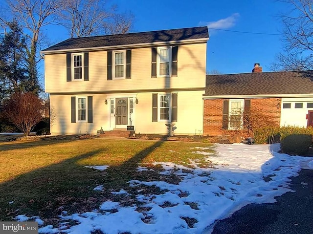 colonial inspired home featuring a yard