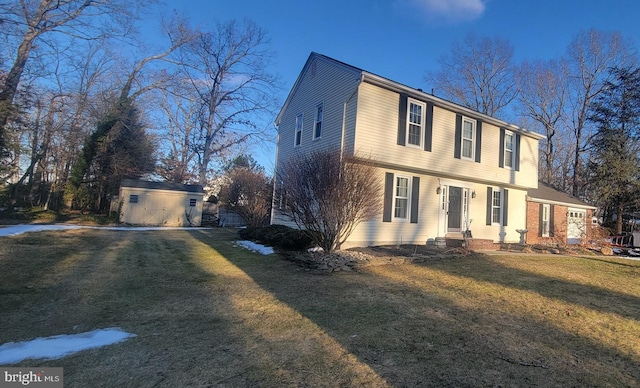 view of front of property featuring a front yard and an outbuilding