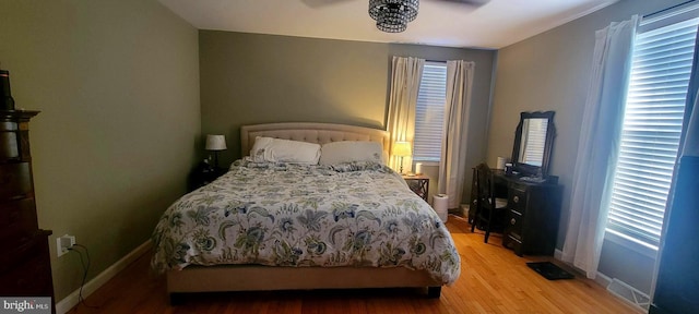 bedroom with ceiling fan and light hardwood / wood-style floors