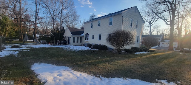 view of snowy exterior featuring a yard