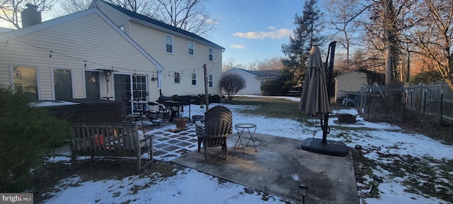 snow covered property featuring a hot tub