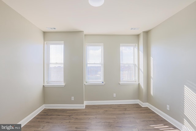 spare room with wood-type flooring