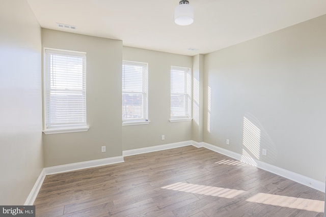 spare room with light hardwood / wood-style flooring