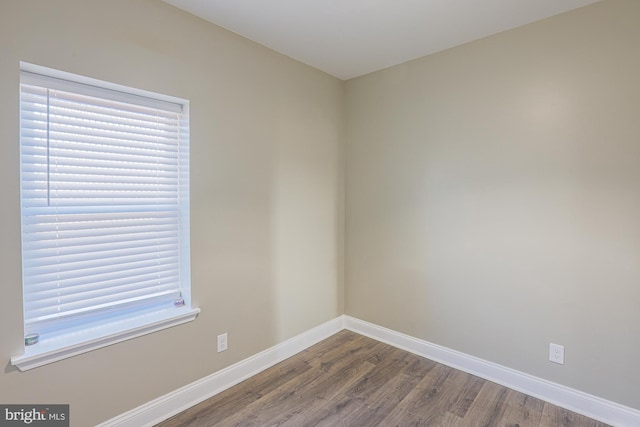 empty room featuring hardwood / wood-style flooring and a healthy amount of sunlight