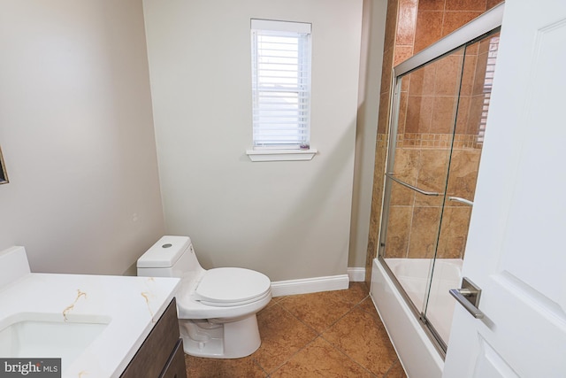 full bathroom featuring vanity, tile patterned flooring, combined bath / shower with glass door, and toilet