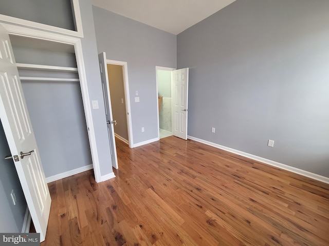 unfurnished bedroom with a closet and wood-type flooring