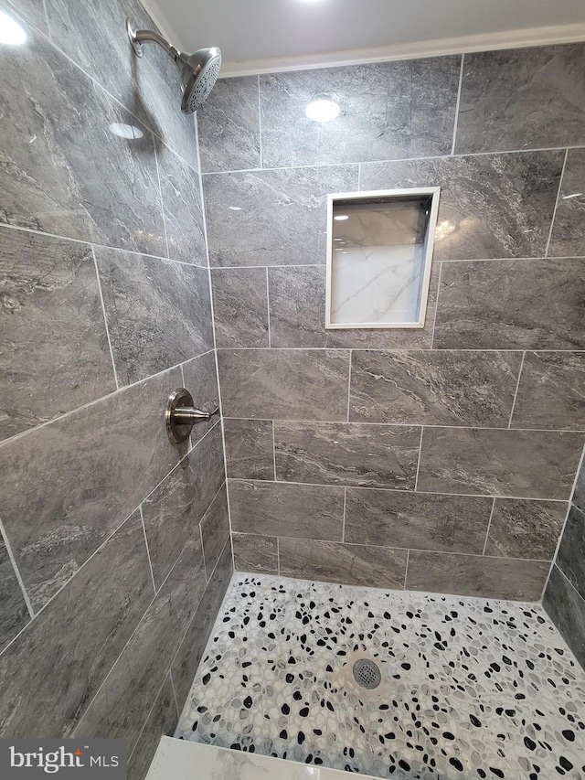 bathroom with a tile shower