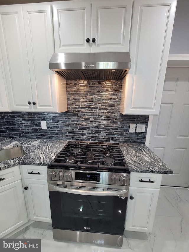 kitchen with white cabinetry, extractor fan, gas range, and tasteful backsplash