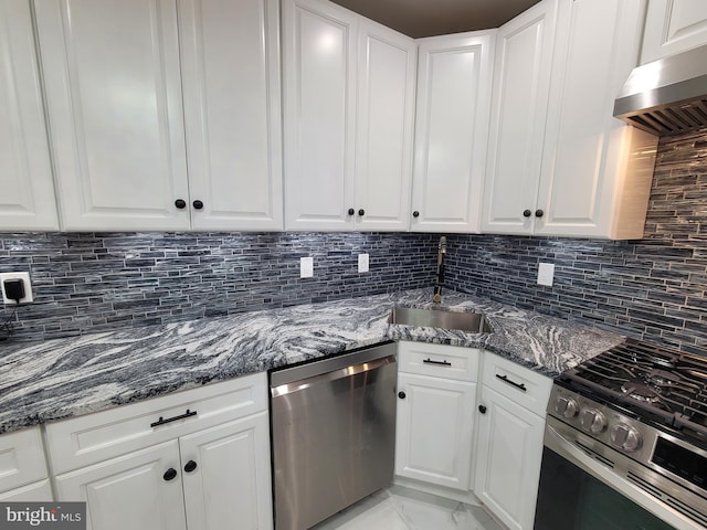 kitchen with stainless steel appliances, sink, white cabinets, decorative backsplash, and ventilation hood