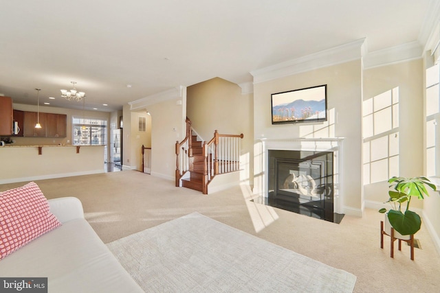 living room with ornamental molding, light carpet, and an inviting chandelier