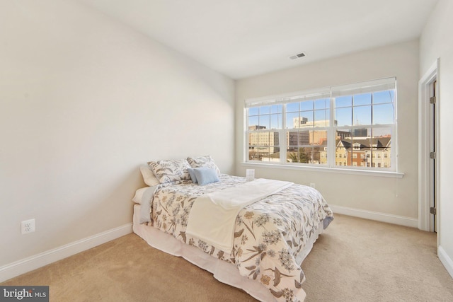 bedroom featuring light colored carpet