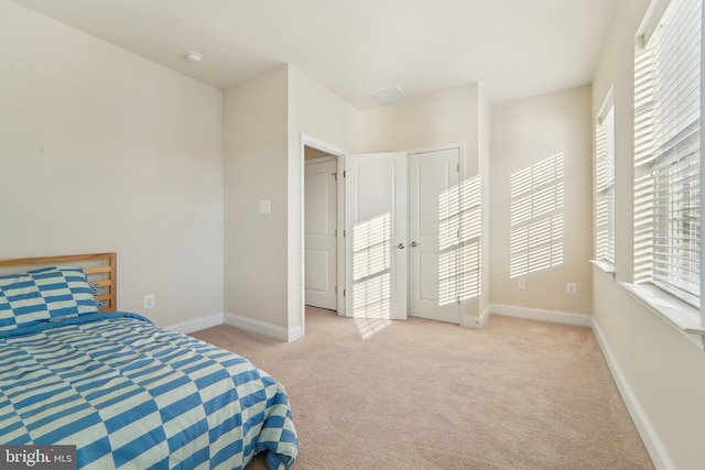 bedroom featuring light carpet