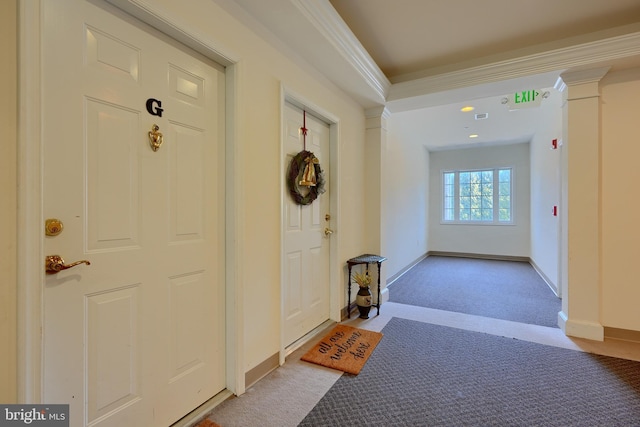 entryway with ornamental molding, light colored carpet, and ornate columns