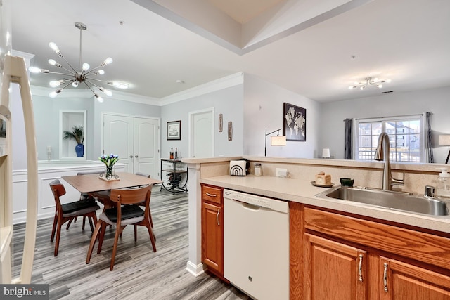 kitchen with light hardwood / wood-style floors, white dishwasher, sink, an inviting chandelier, and decorative light fixtures