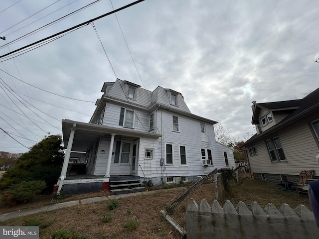 view of front of house featuring cooling unit and covered porch