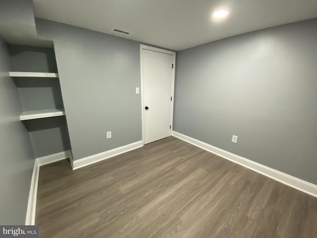 unfurnished bedroom featuring dark hardwood / wood-style flooring