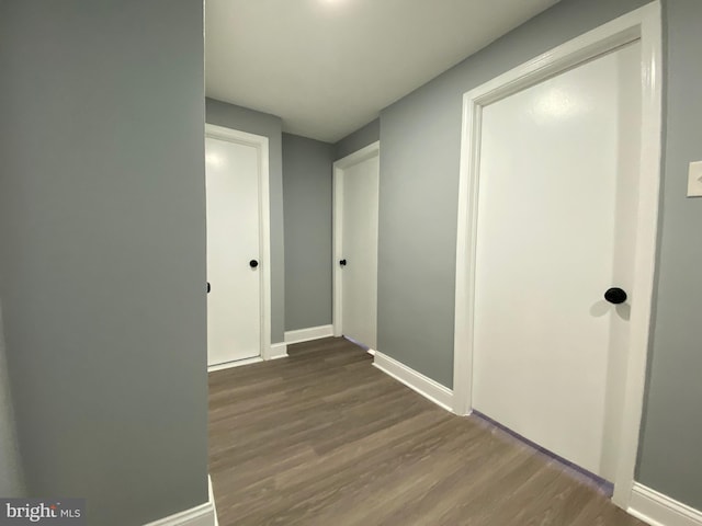 corridor featuring dark wood-type flooring