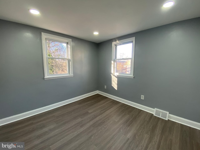 spare room featuring dark hardwood / wood-style floors