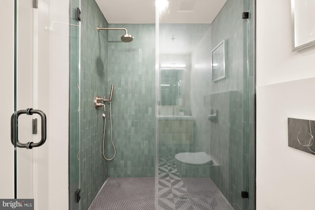 bathroom featuring a shower with door