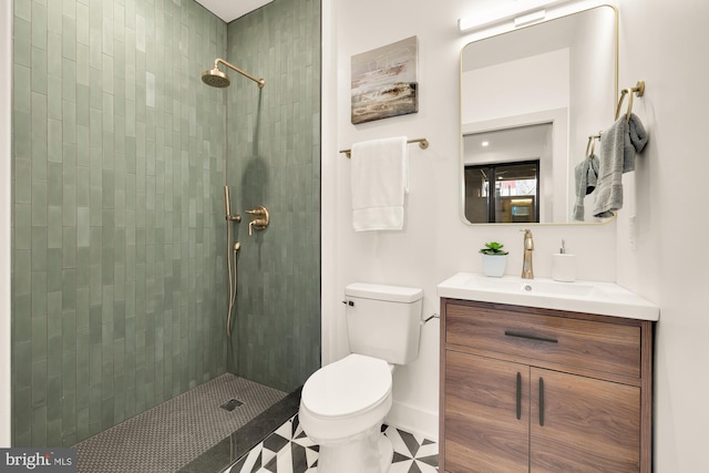 bathroom featuring tiled shower, vanity, and toilet